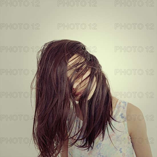 Mixed race girl tossing her hair