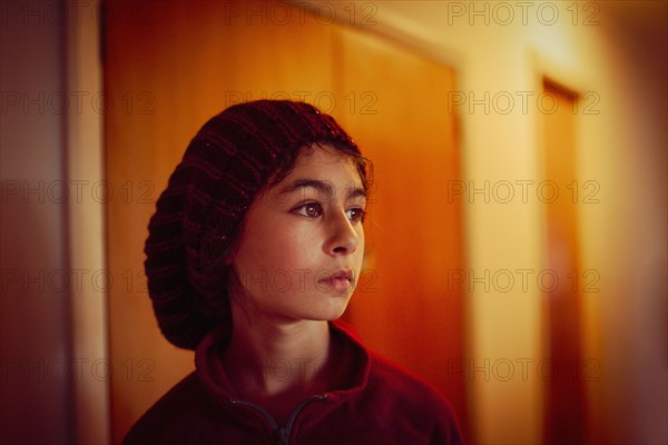 Mixed race girl standing in hallway