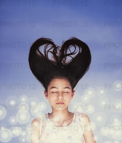 Mixed race girl with heart-shaped hair