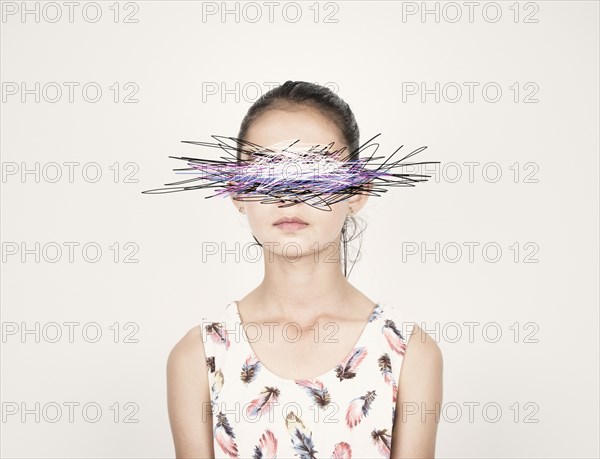 Mixed race girl with eyes scribbled out