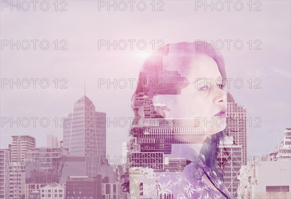 Double exposure of mixed race woman and cityscape