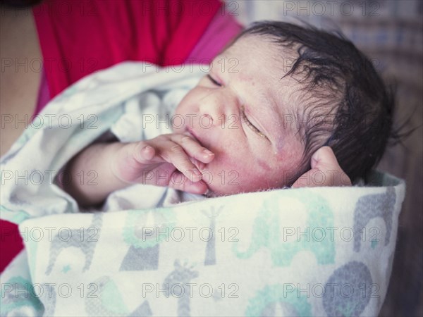 Close up of mother holding newborn baby son