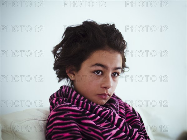Mixed race girl wrapped in bathrobe