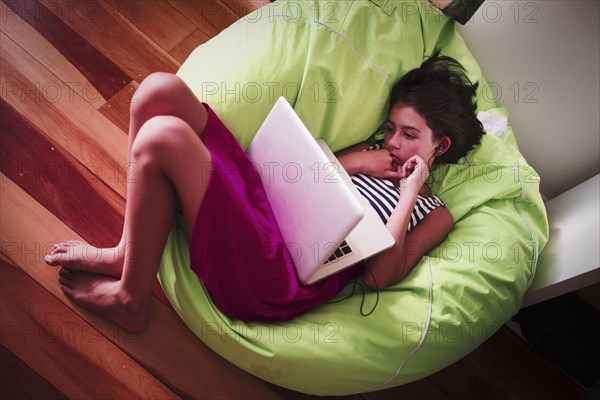 Girl using laptop in beanbag