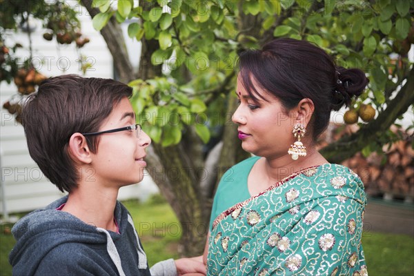 Mother and son talking in garden