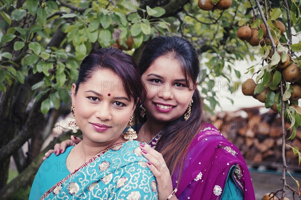 Women wearing traditional Indian dresses in garden
