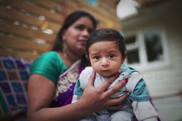 Indian woman holding baby son