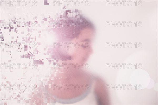 Mixed race girl dissolving into pixels