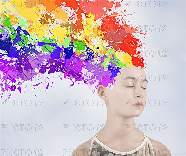 Paint splatter exploding from head of Mixed Race girl