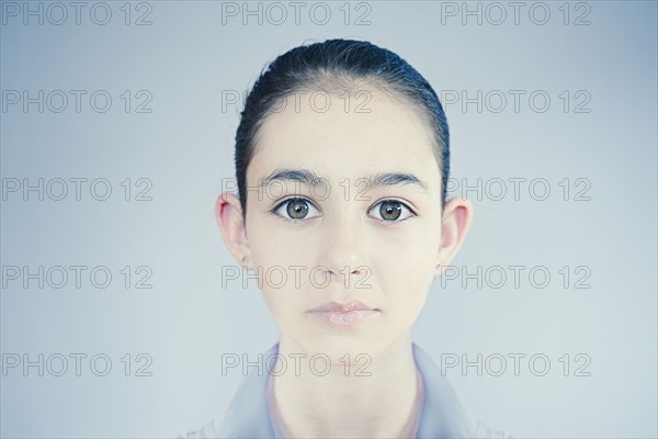Face of wide-eyed Mixed Race girl