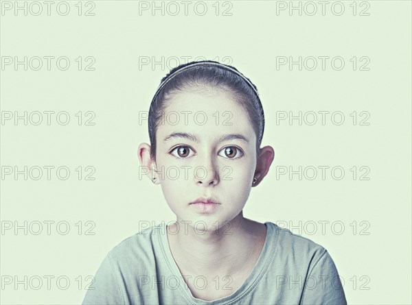 Serious wide-eyed Mixed Race girl