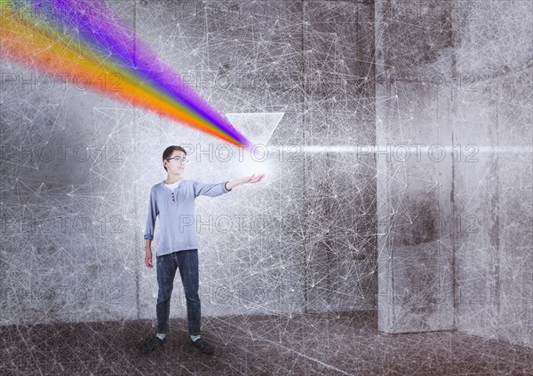 Mixed Race boy holding prism