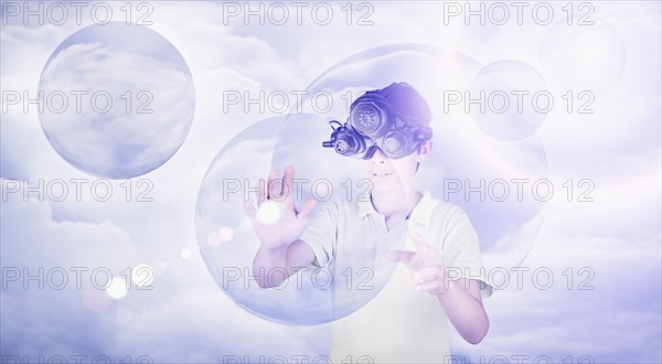 Mixed Race boy using virtual reality goggles