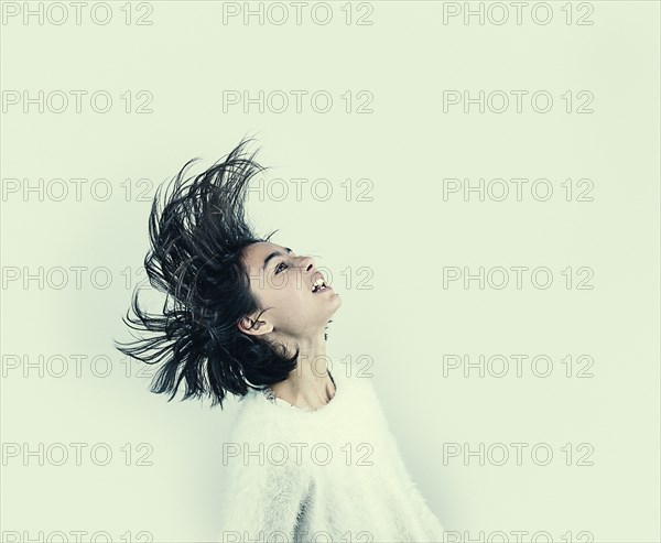 Mixed Race girl tossing hair