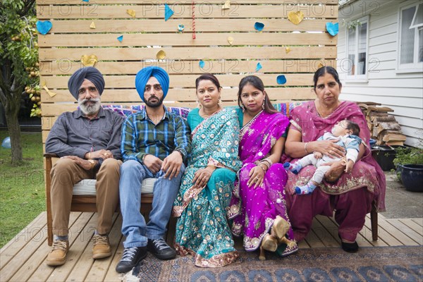 Portrait of smiling family on outdoor bench