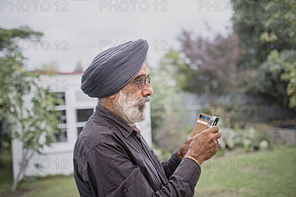 Indian man texting on cell phone