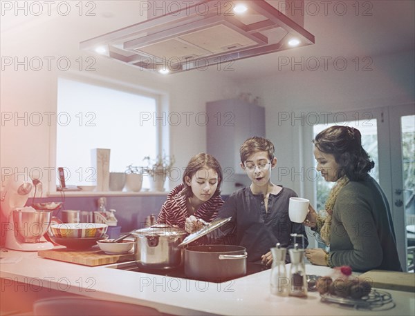 Family cooking food in kitchen