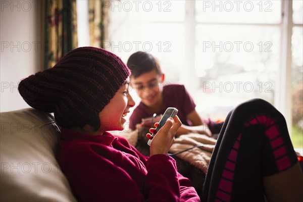 Smiling Mixed Race using cell phone