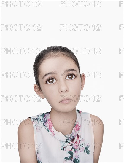 Portrait of sad Mixed Race girl with big eyes