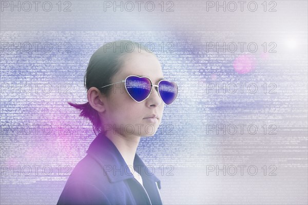 Mixed Race girl wearing heart-shape sunglasses in data cloud