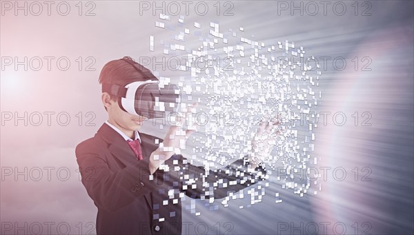 Mixed Race boy wearing suit using vr goggles