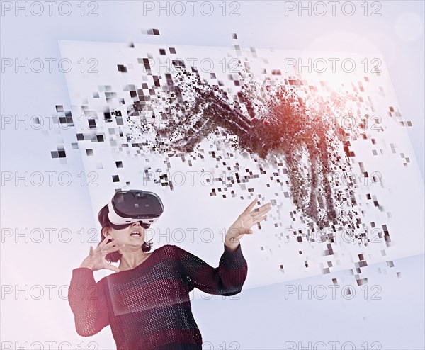 Mixed Race girl using virtual reality goggles watching spider