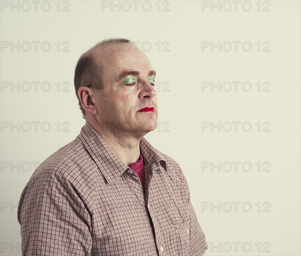 Caucasian man wearing makeup