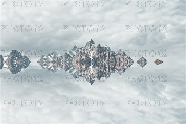 Mirror image of mountains and clouds