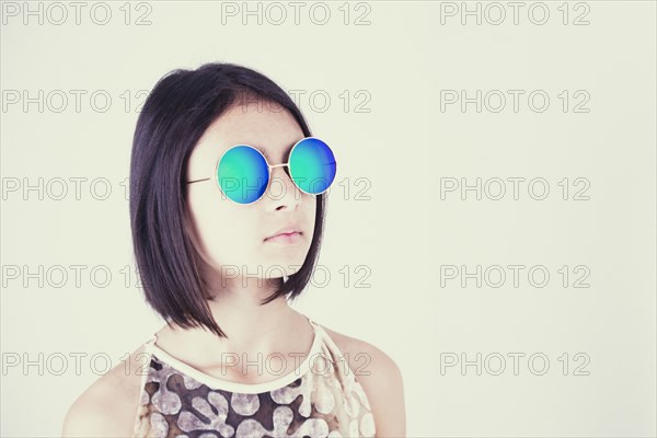 Mixed Race girl wearing blue sunglasses