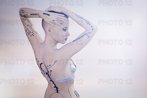 Tattoos on arms and back of futuristic woman