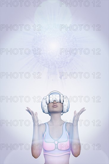 Woman using virtual reality helmet under pixelated sphere