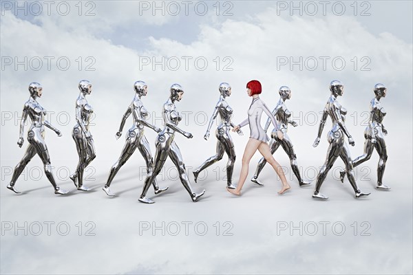 Woman walking in opposite direction of robots