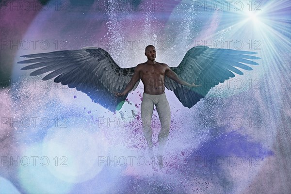 Man with angel wings flying in purple sky