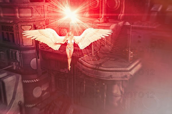 Woman wearing bikini flying with angel wings in industrial space