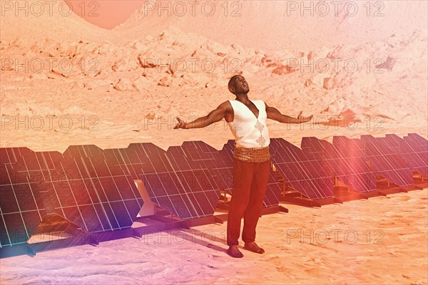 Man standing in sunny desert near solar panels
