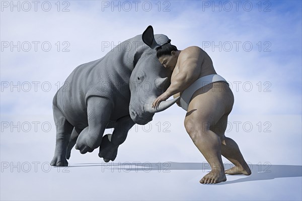 Sumo wrestler fighting rhinoceros