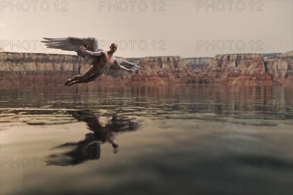 Angel flying over water