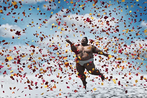 Sumo wrestler floating in autumn leaves