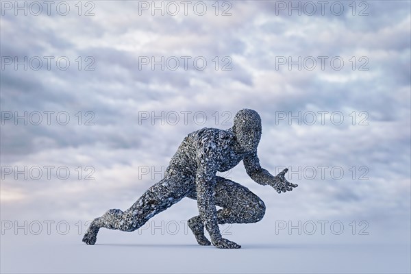 Stone man crouching under cloudy sky