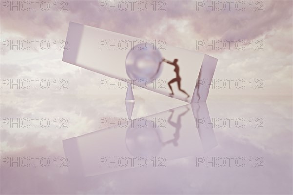 Silhouette of a woman pushing sphere on fulcrum