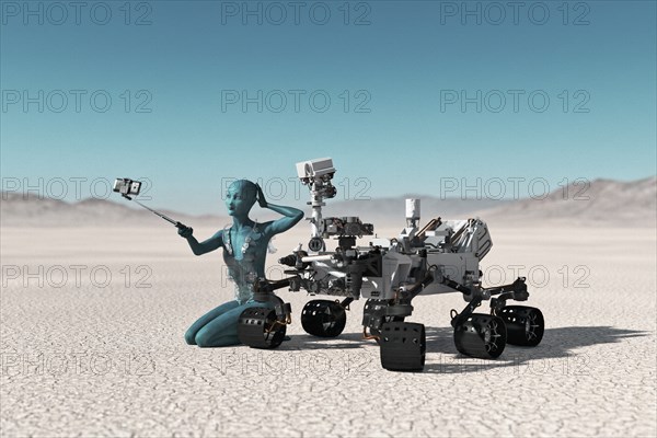 Futuristic woman posing for cell phone selfie in desert
