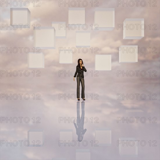 Cubes floating above pensive businesswoman