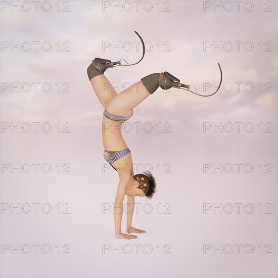 Woman with artificial legs performing handstand