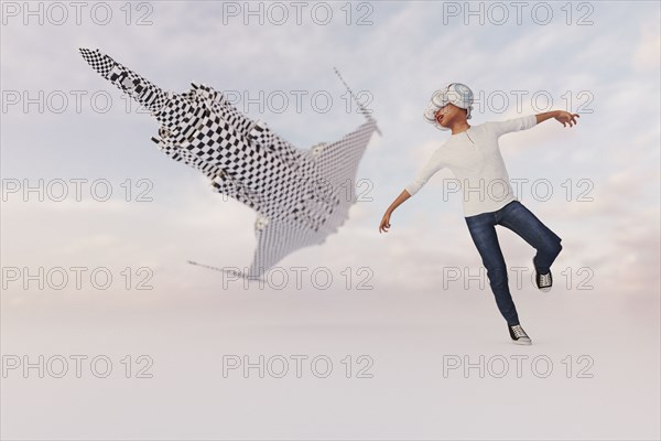 Boy wearing virtual reality goggles imitating airplane