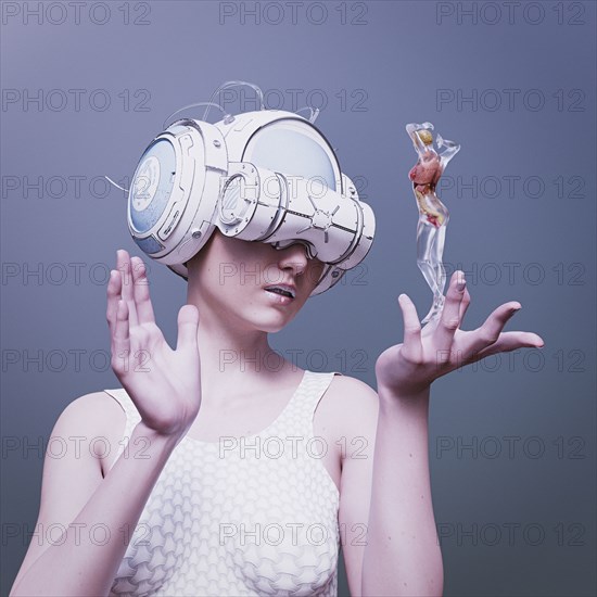 Woman wearing virtual reality helmet holding a transparent woman
