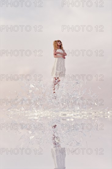 Woman hovering in shards of glass