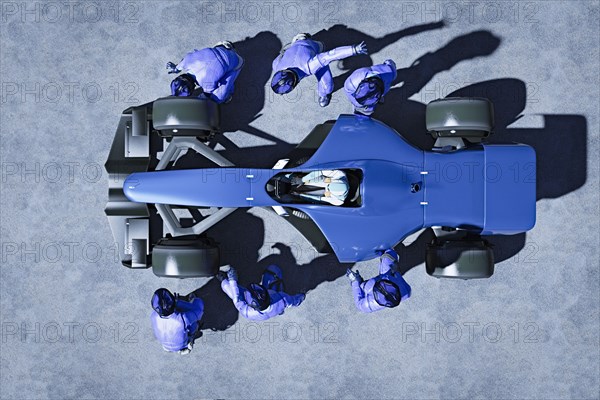 Futuristic pit crew servicing race car