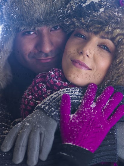 Couple in fur caps hugging