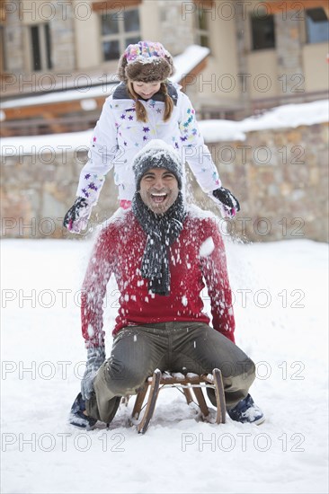 Father and daughter playing in snow