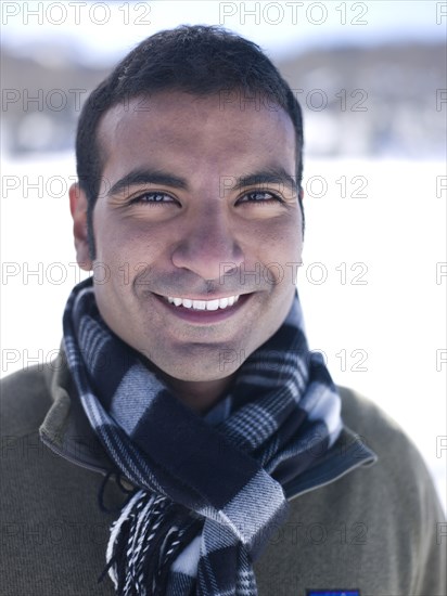 Smiling man standing in snow